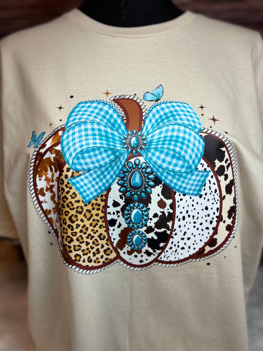 Decorative heat press t-shirt with a western pumpkin that has blue checkered bow, leopard print, and polka dot patterns.