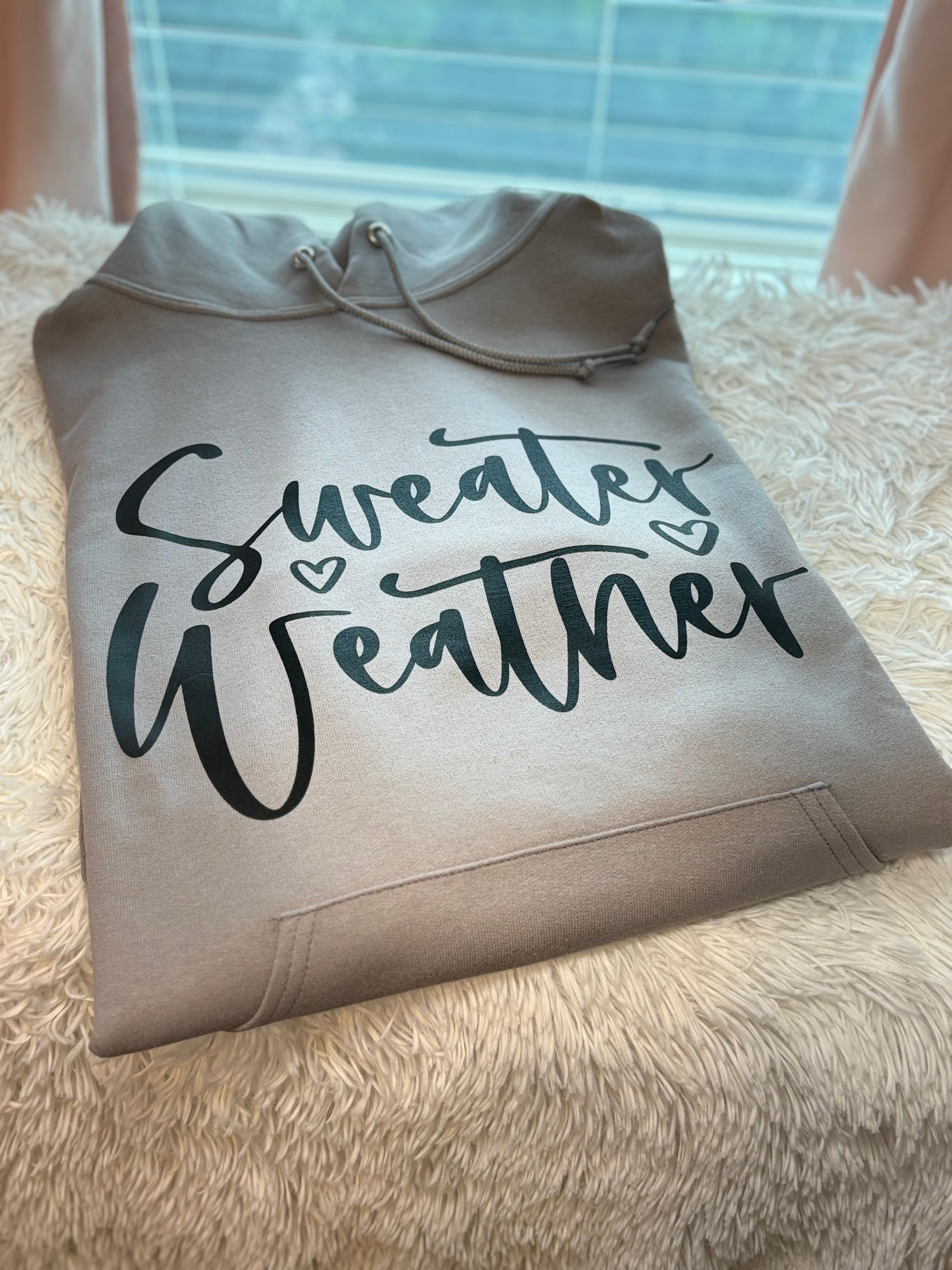 Gray heat press hoodie with 'Sweater Weather' text in black