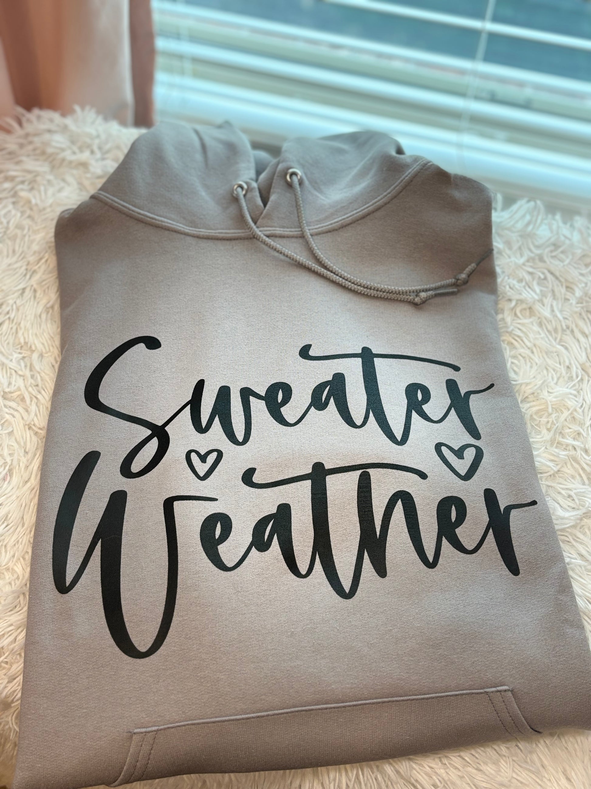 Gray heat press hoodie with 'Sweater Weather' text in black