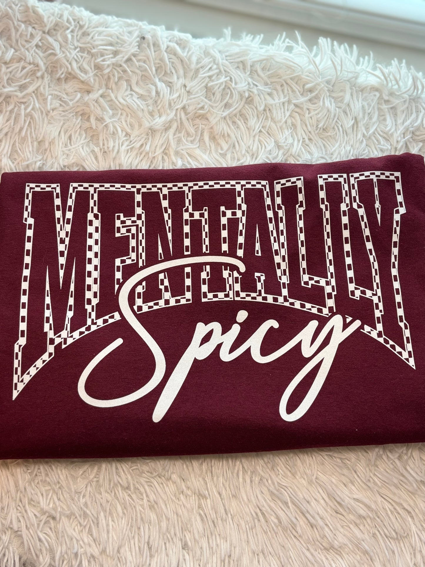 Maroon heat press t-shirt with 'Mentally Spicy' text in white- checkered outline