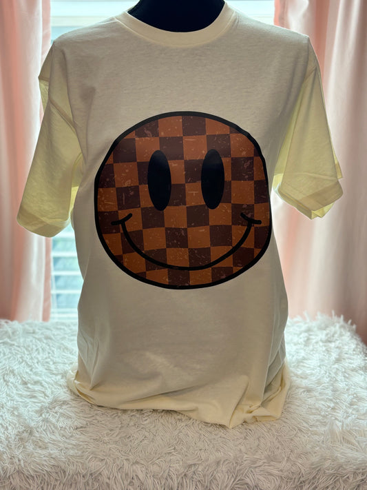 Cream heat press t-shirt with a checkered smiley face design 