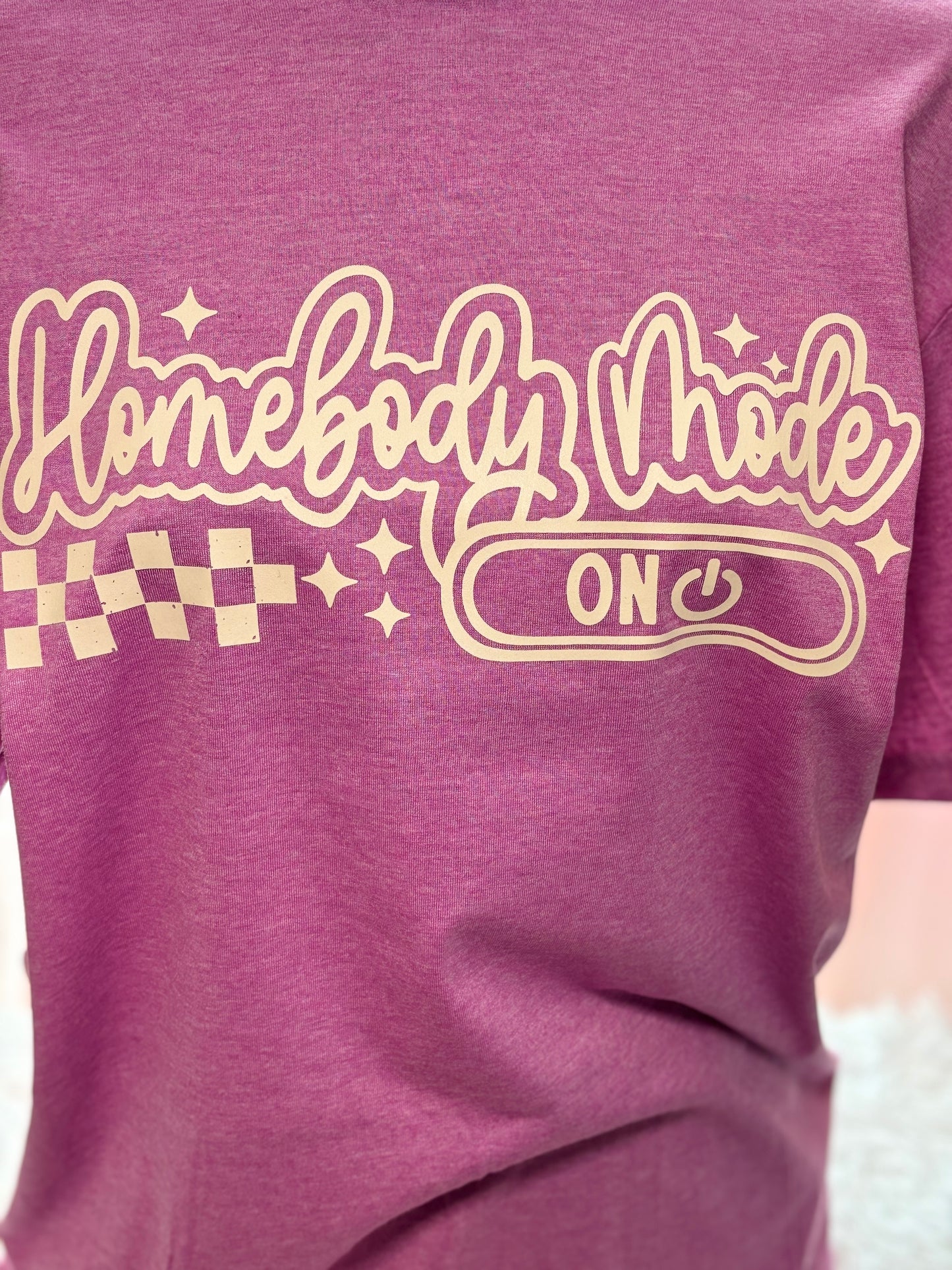 Heather Orchid heat press t-shirt with 'Homebody Mode ON' text in beige