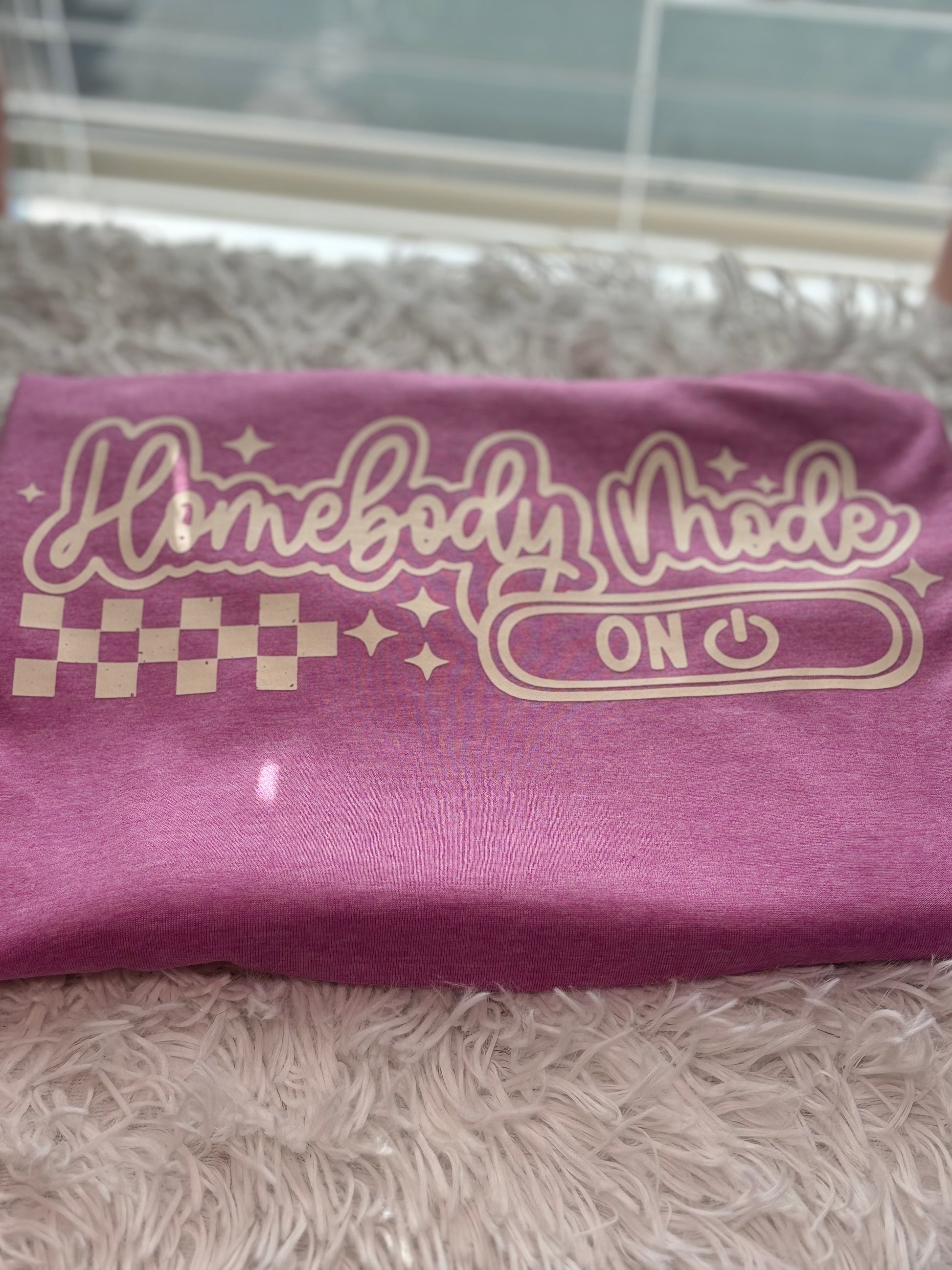Heather Orchid heat press t-shirt with 'Homebody Mode ON' text in beige