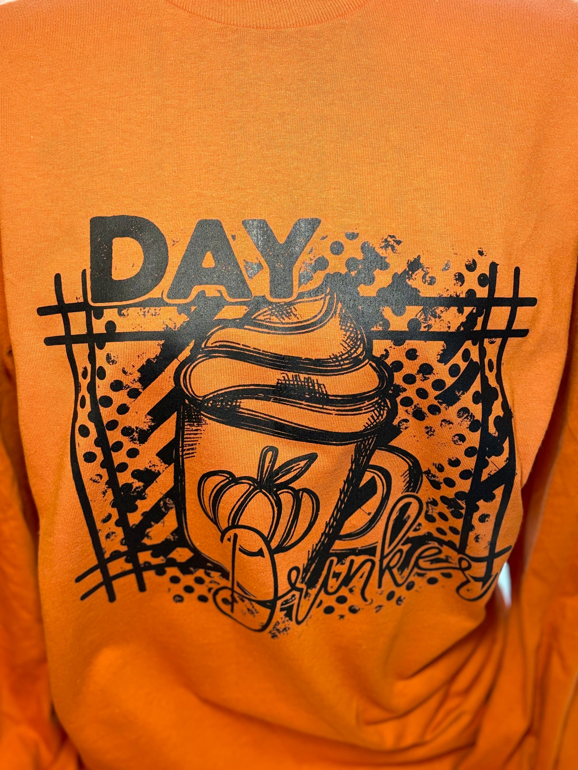 Orange long sleeve t-shirt with black graphic heat press design- Day Drinker latte