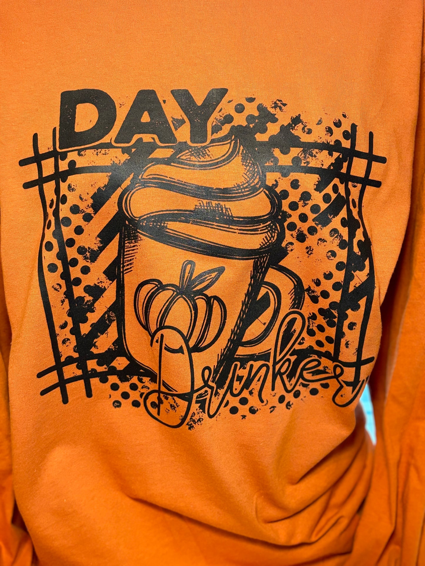 Orange long sleeve t-shirt with black graphic heat press design- Day Drinker latte