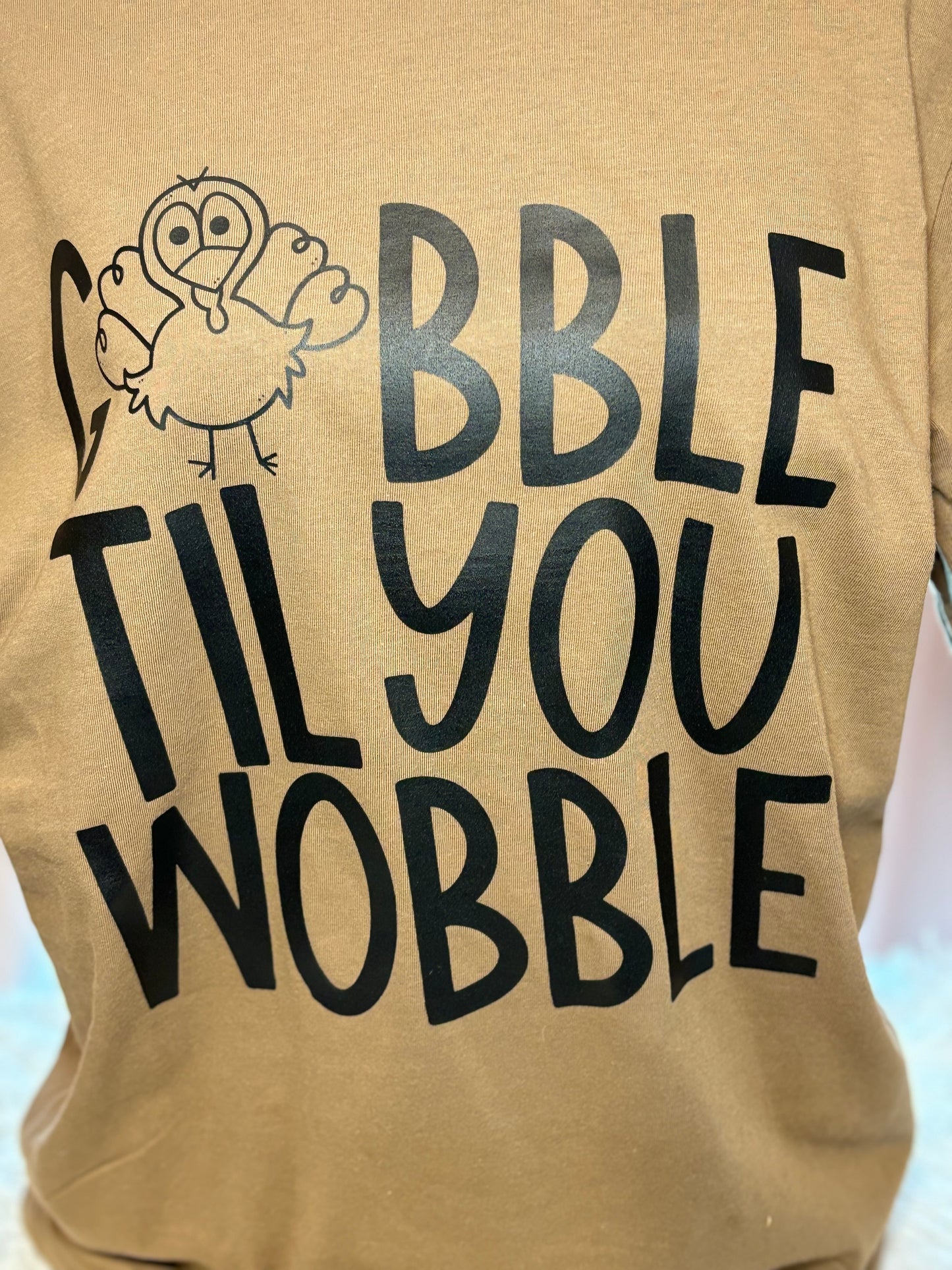 Brown heat press t-shirt with 'Gobble Til You Wobble' text and a turkey graphic 