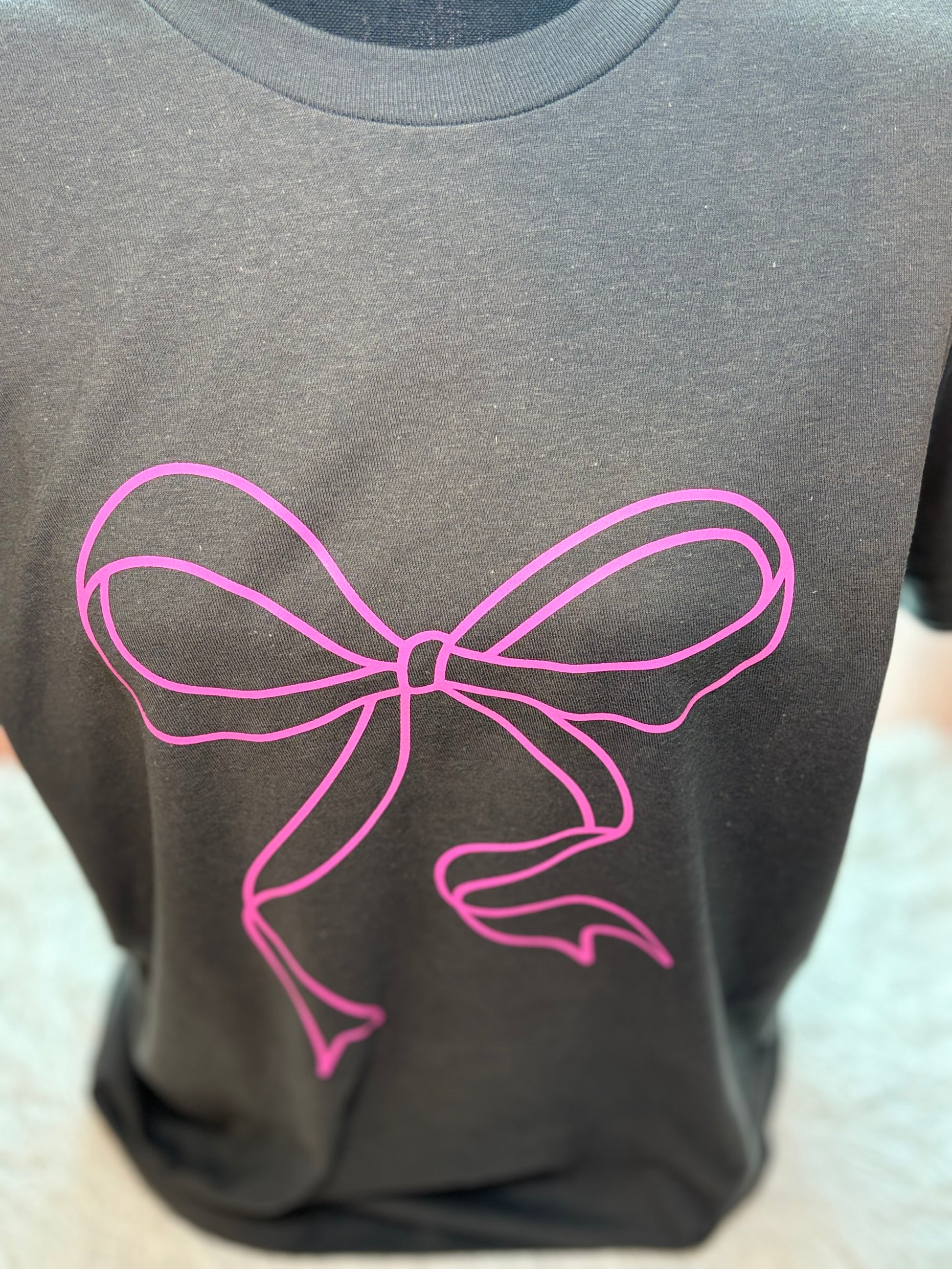 Charcoal heat press t-shirt with a pink bow design 