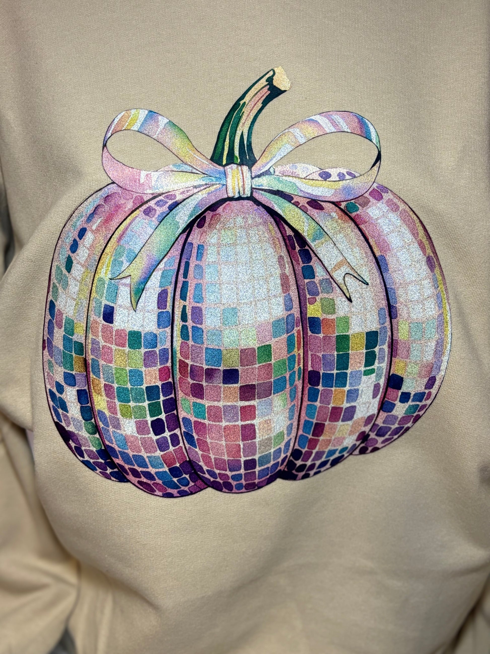 Heat pressed beige sweatshirt with a glitter disco pumpkin design 