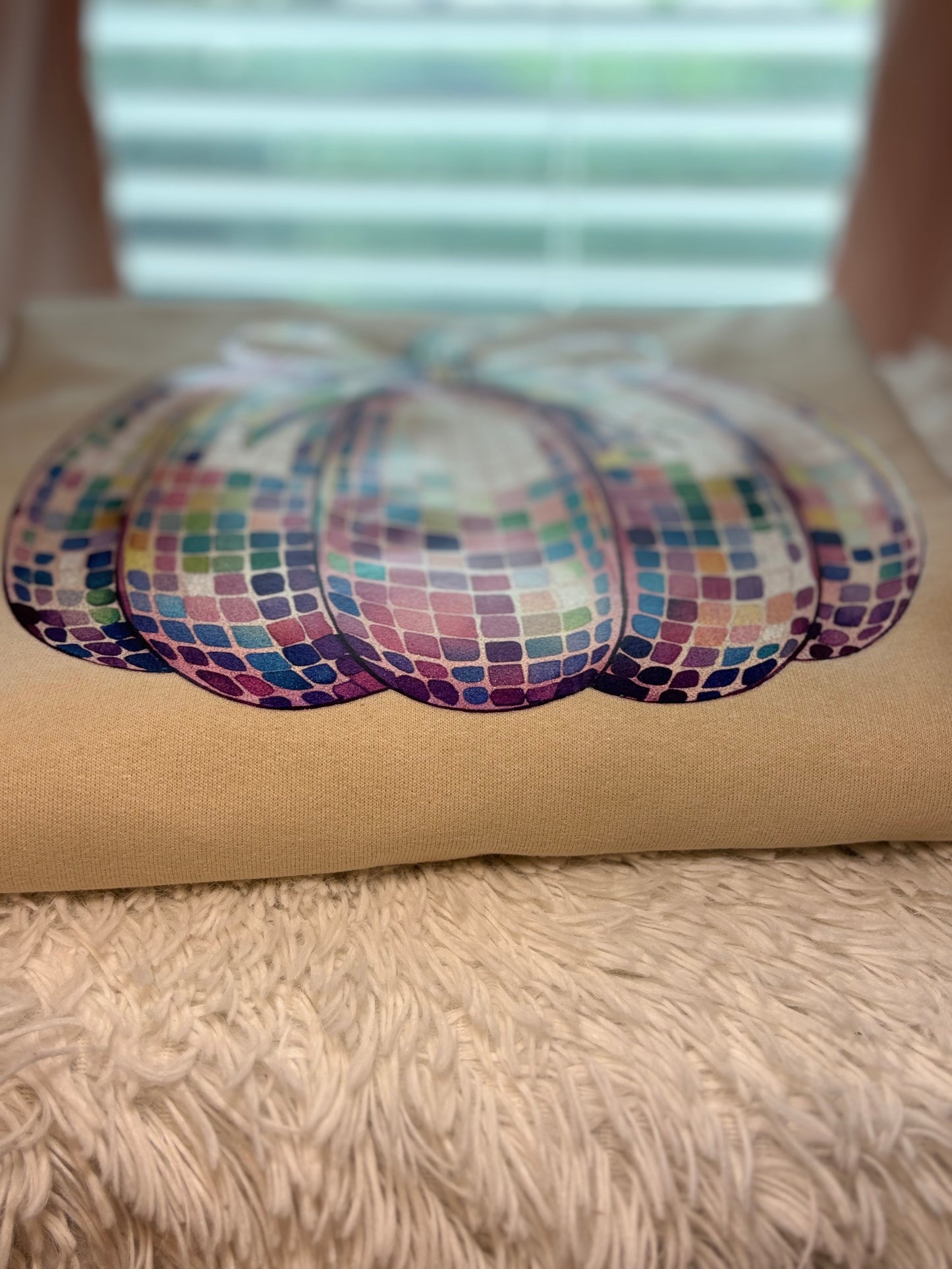 Heat pressed beige sweatshirt with a glitter disco pumpkin design 