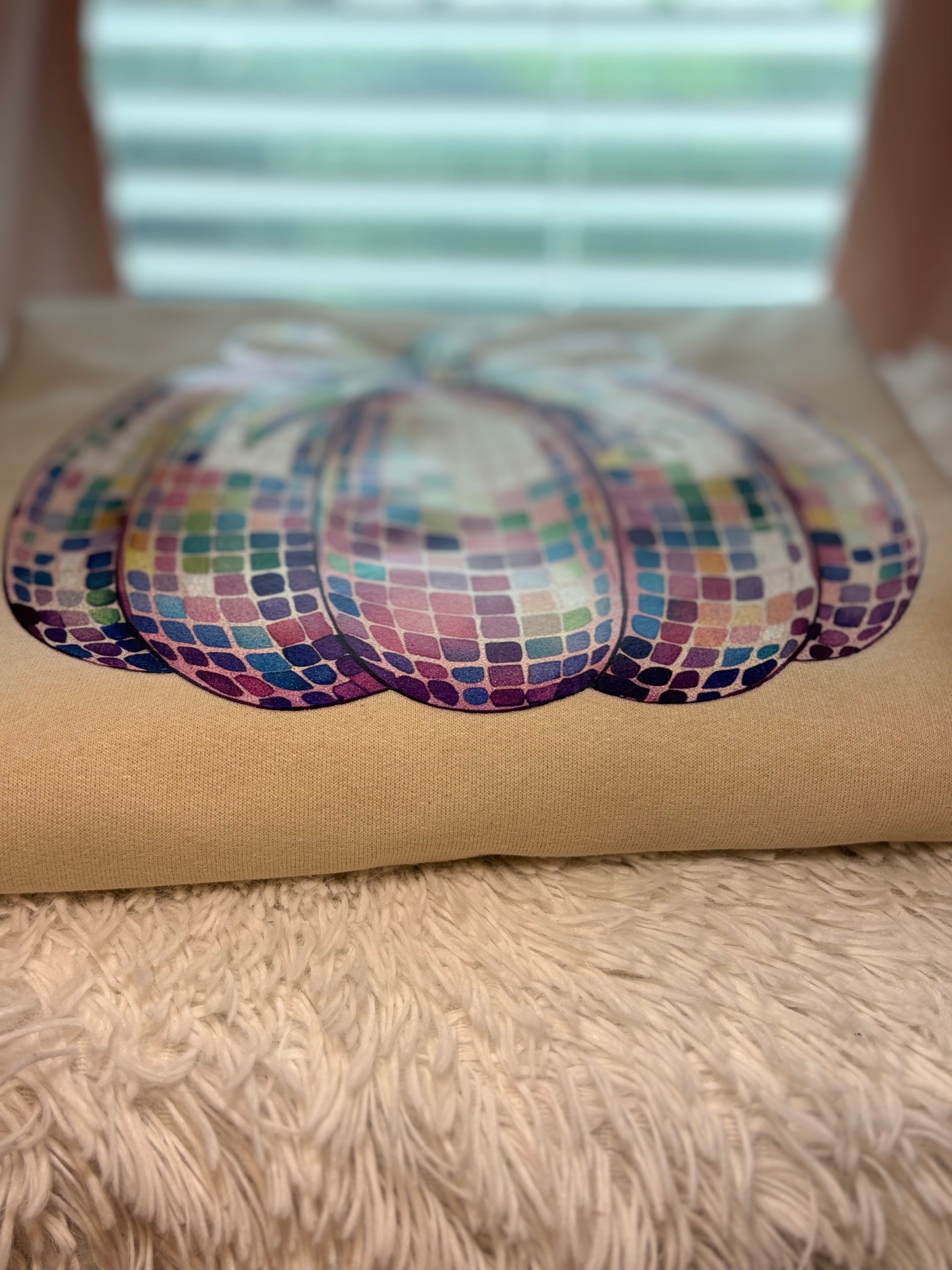 Heat pressed beige sweatshirt with a glitter disco pumpkin design 