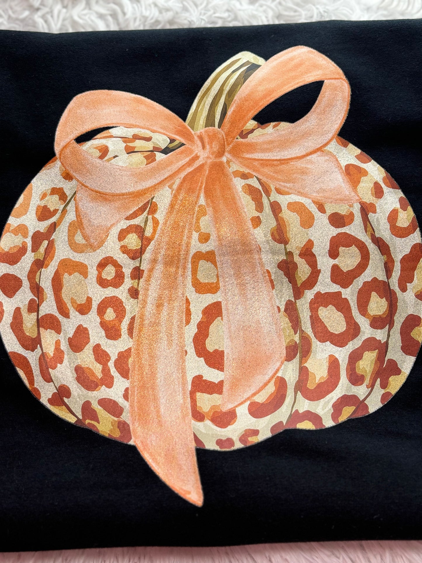 Black t-shirt with a heat press glitter leopard print pumpkin design 