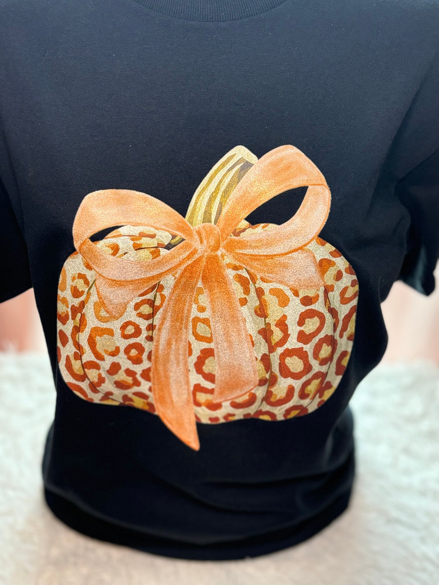 Black t-shirt with a heat press glitter leopard print pumpkin design 