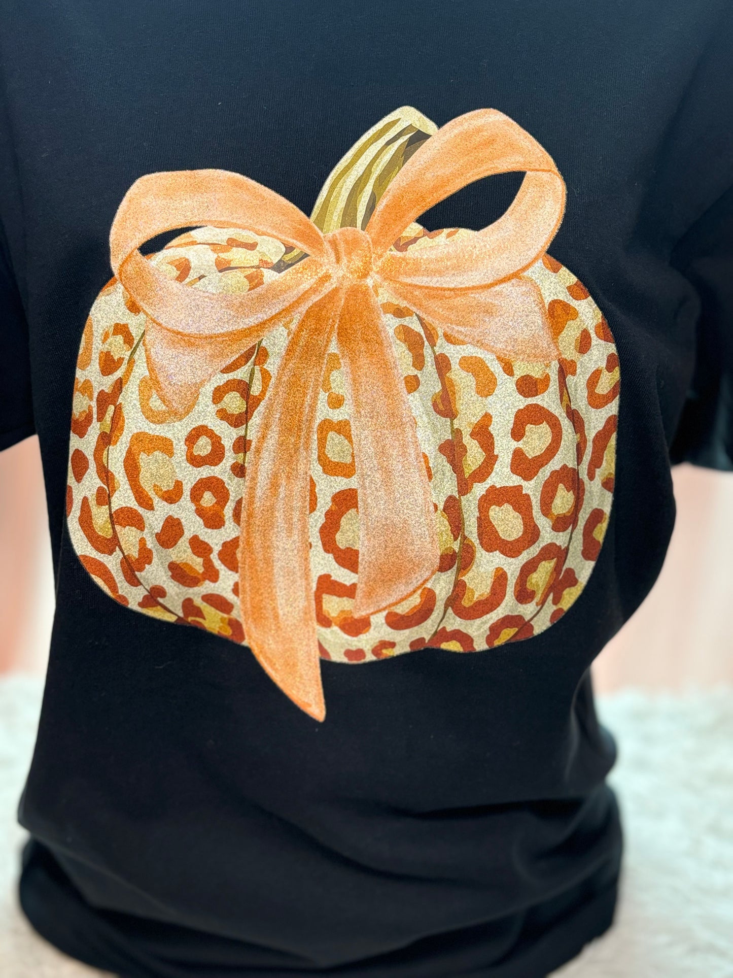 Black t-shirt with a heat press glitter leopard print pumpkin design 