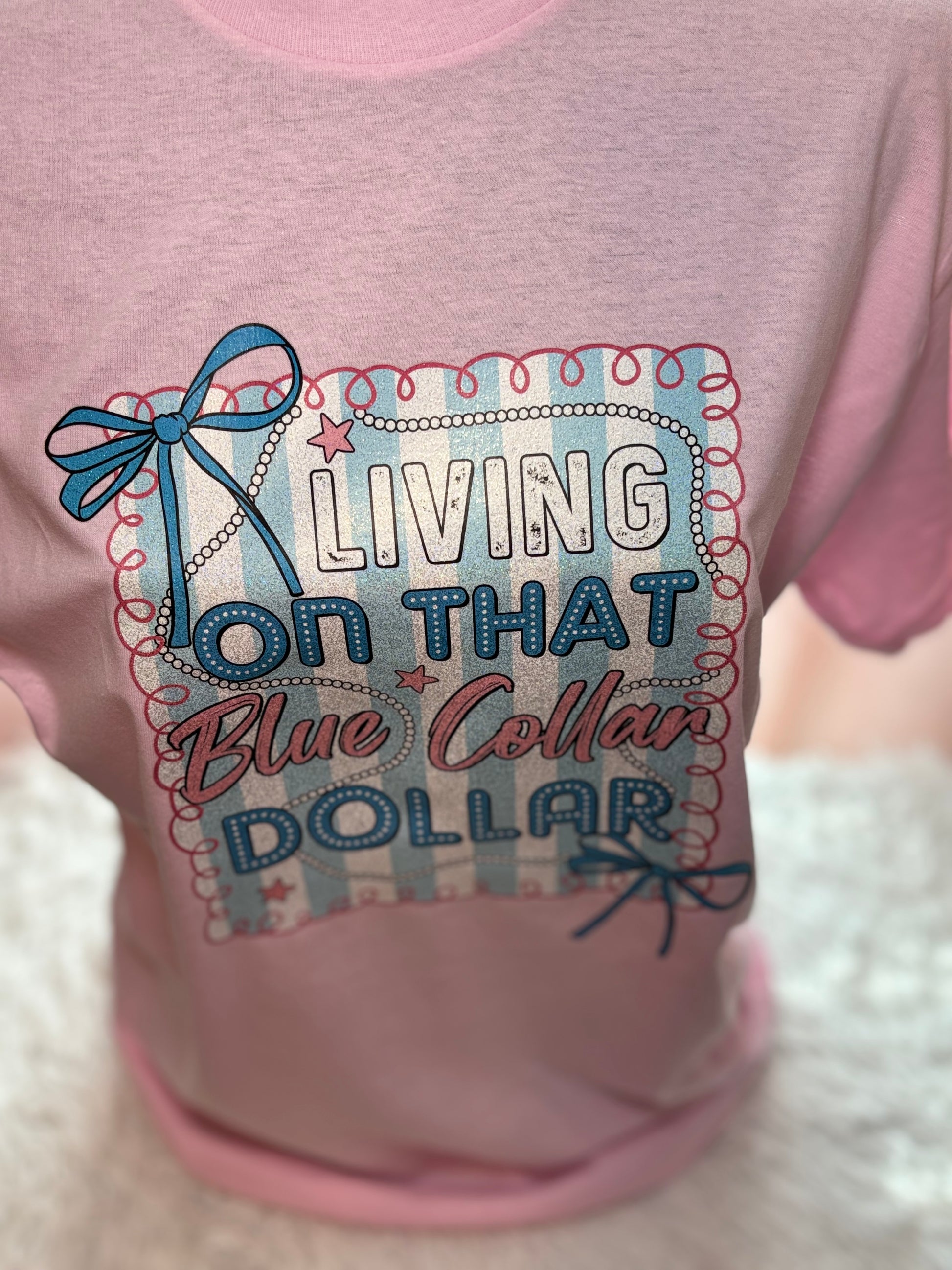 Pink heat press t-shirt with "Living on that Blue Collar Dollar" text and decorative elements