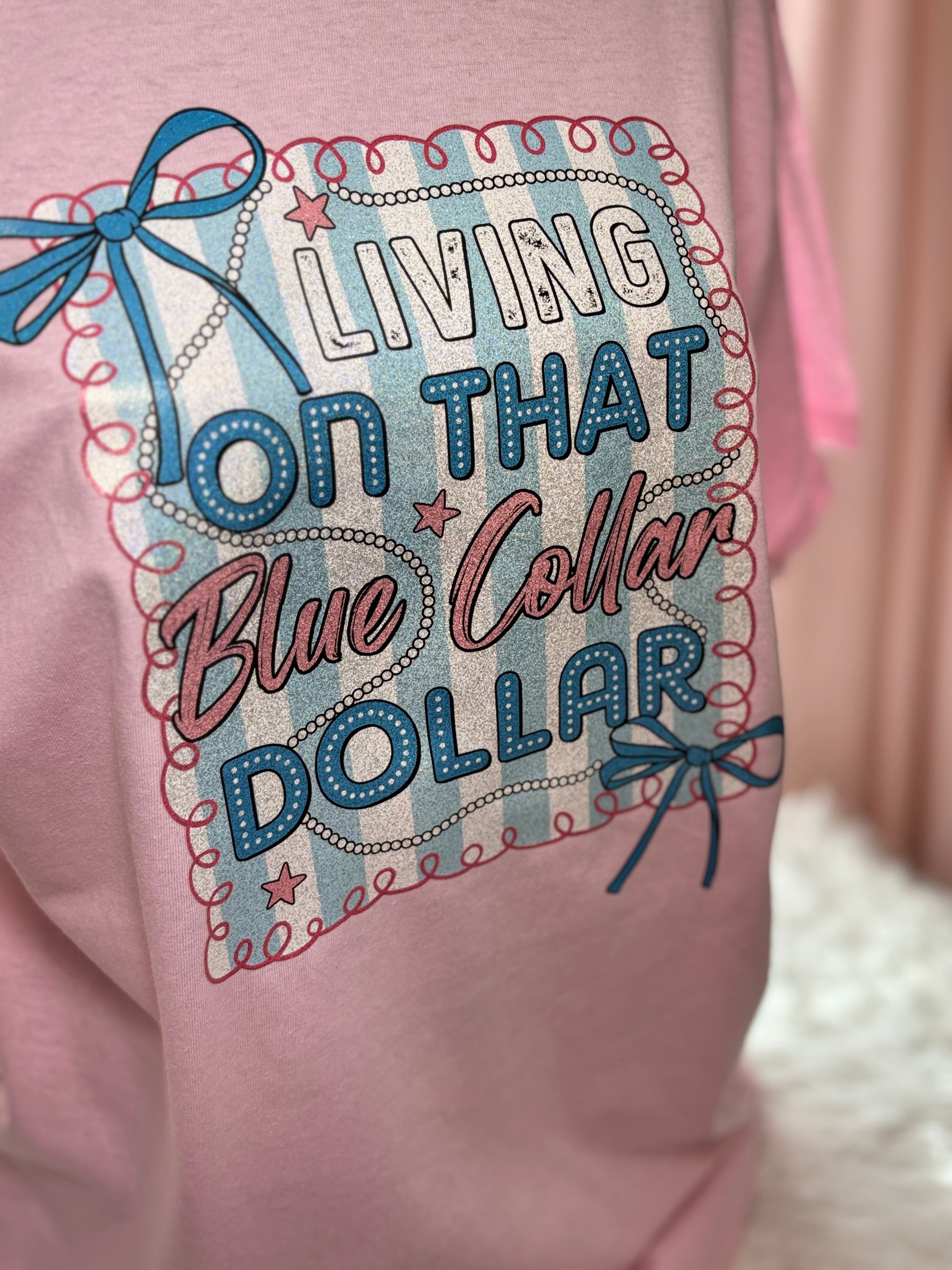 Pink heat press t-shirt with "Living on that Blue Collar Dollar" text and decorative elements