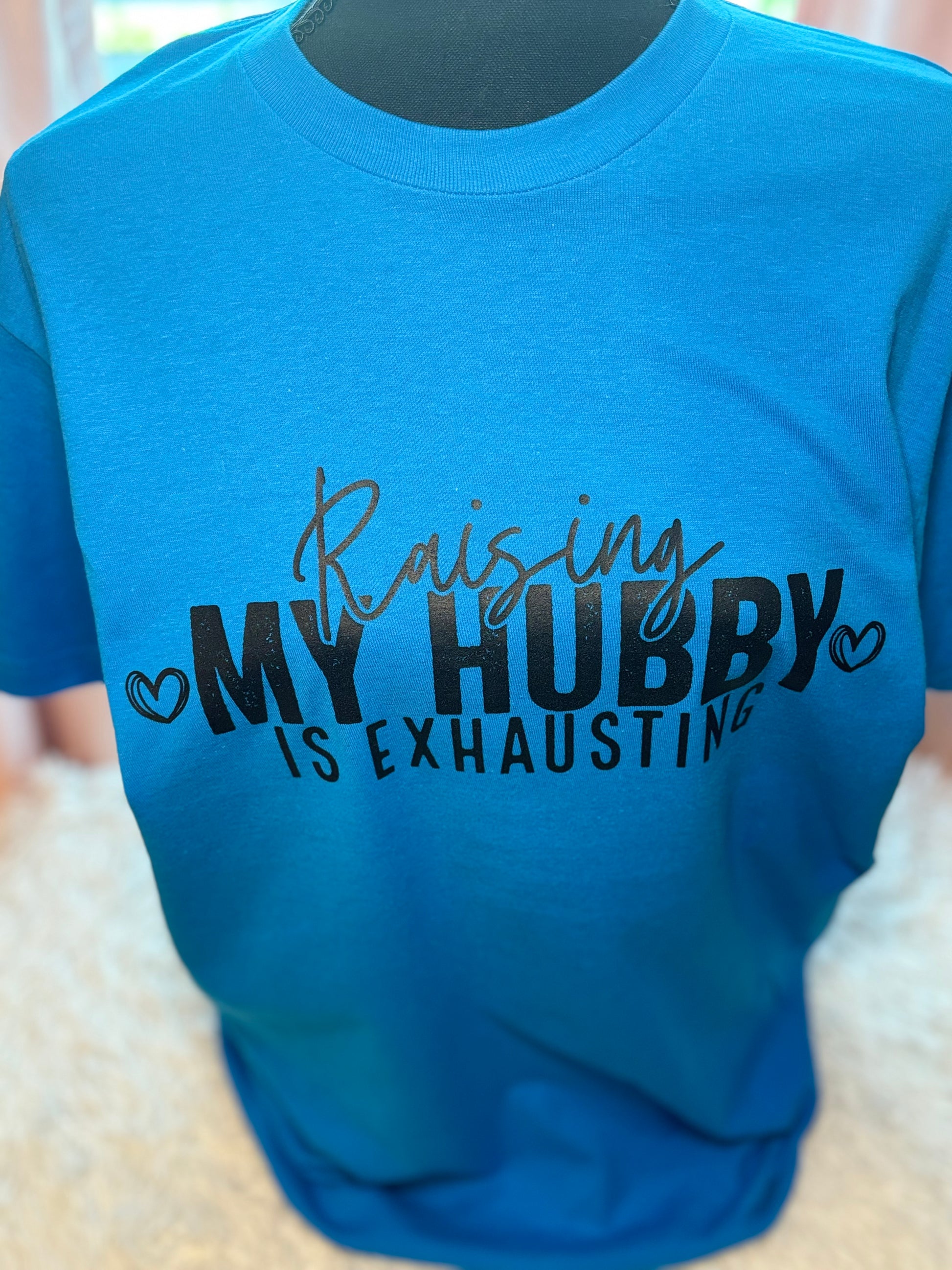 Turquoise heat press t-shirt with text 'Raising MY HUBBY IS EXHAUSTING' in black