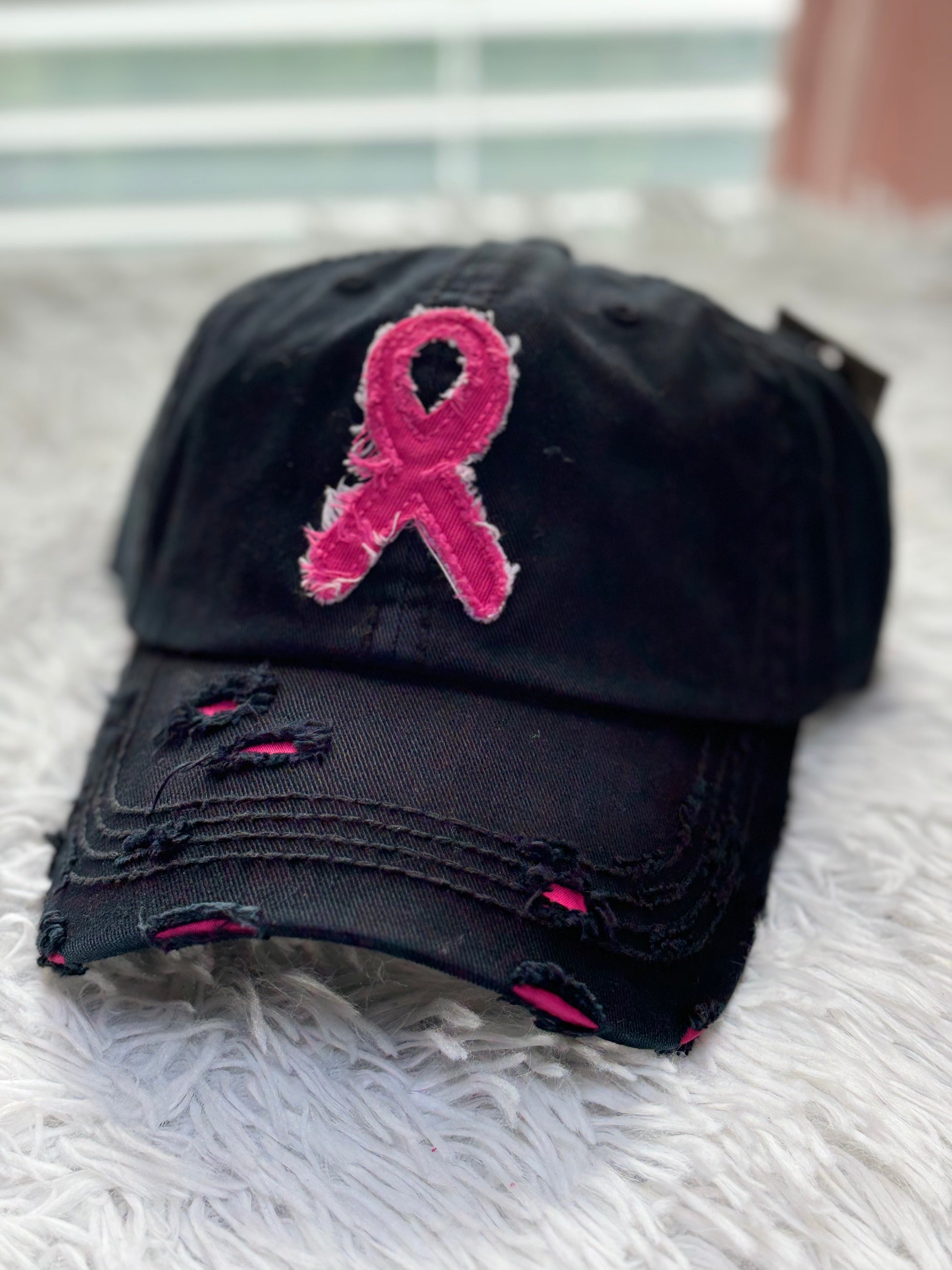 Black distressed baseball cap with a pink breast cancer awareness ribbon 