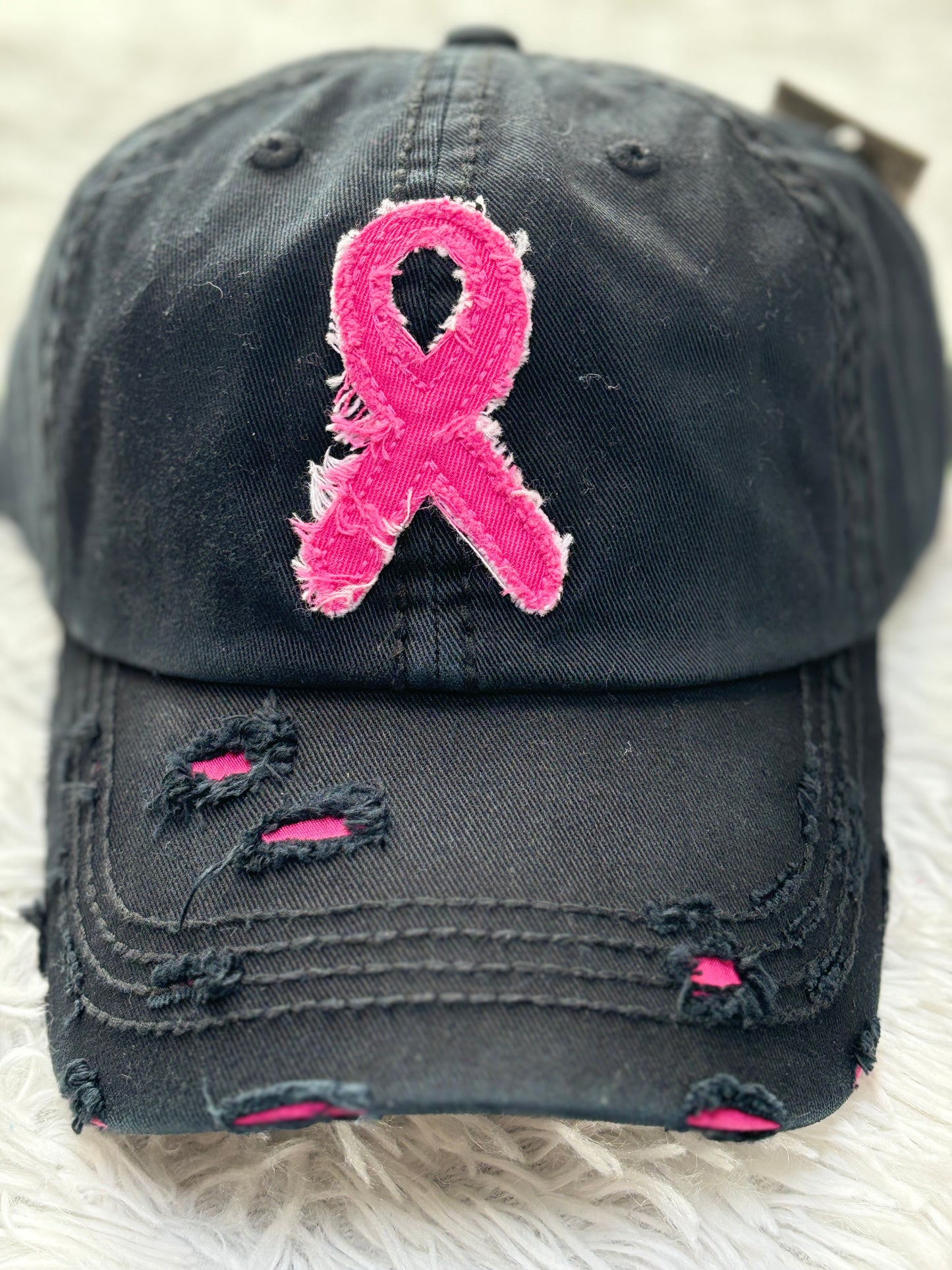 Black distressed baseball cap with a pink breast cancer awareness ribbon 