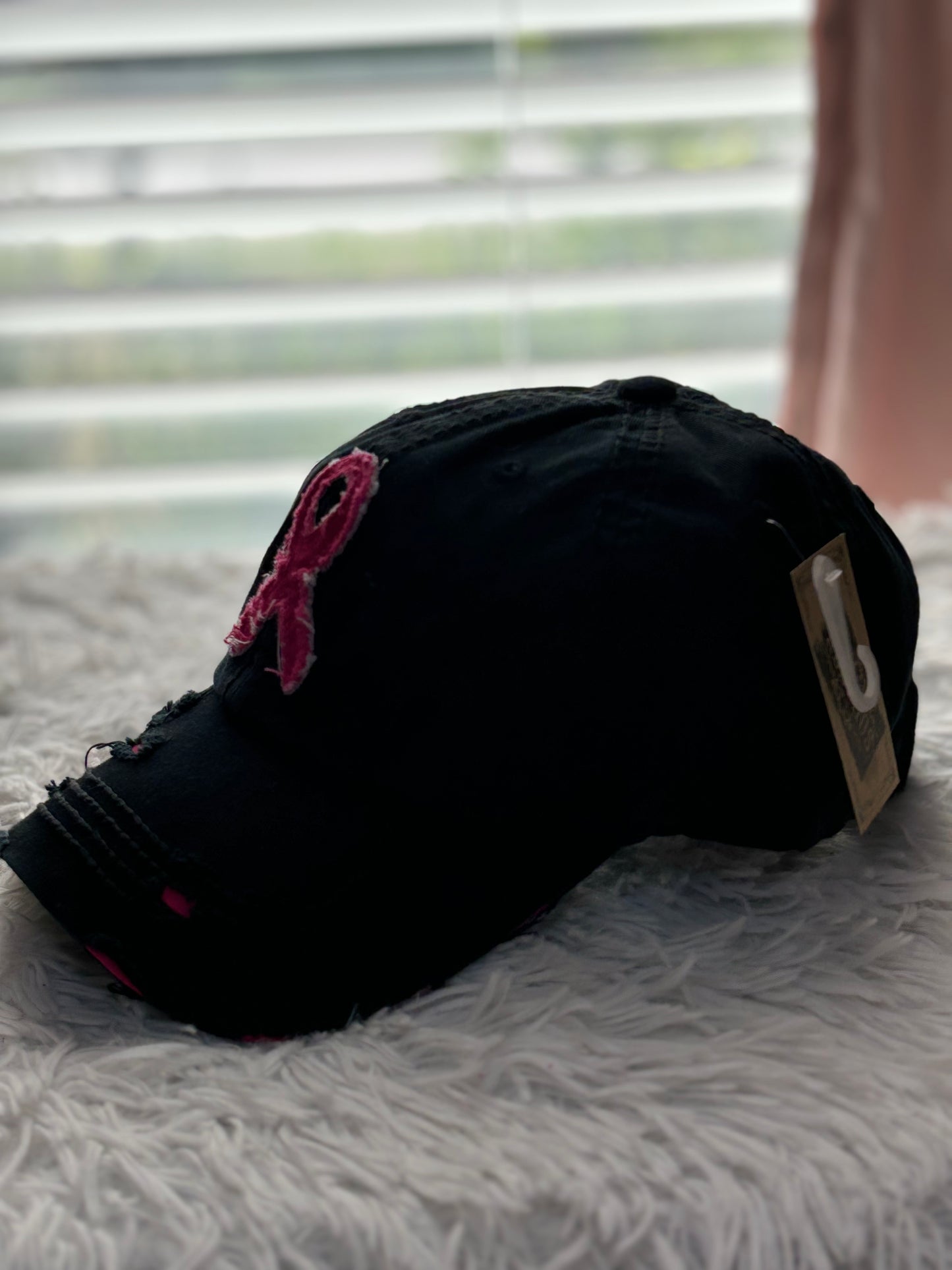 Black distressed baseball cap with a pink breast cancer awareness ribbon 