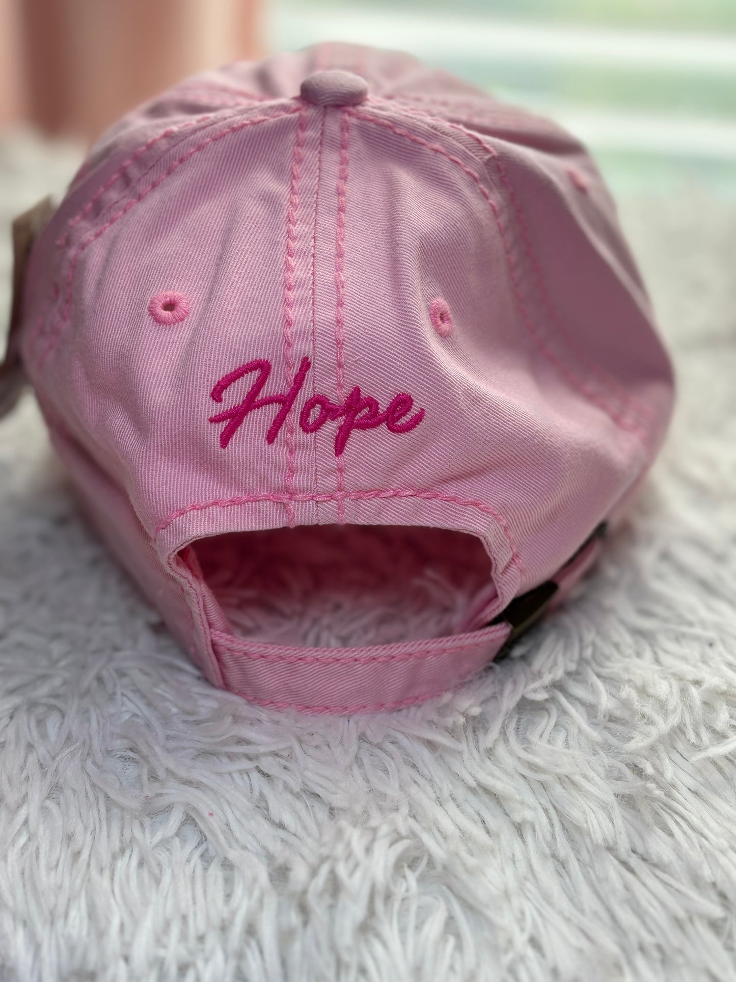 Pink baseball cap with a breast cancer awareness ribbon