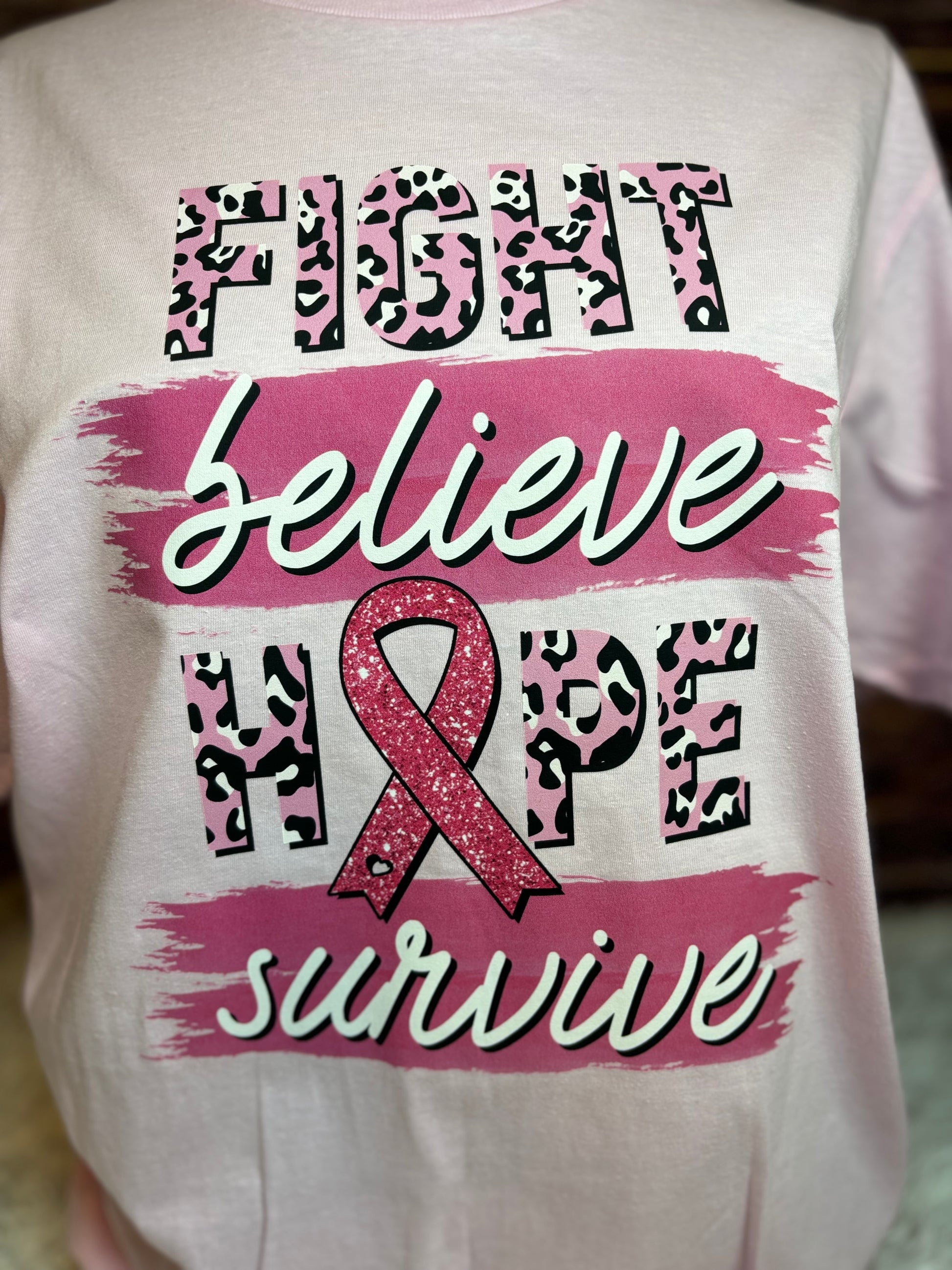 Light pink heat pressed t-shirt with "Fight, Believe, Hope, Survive." Breast Cancer Awareness t-shirt. Features leopard print