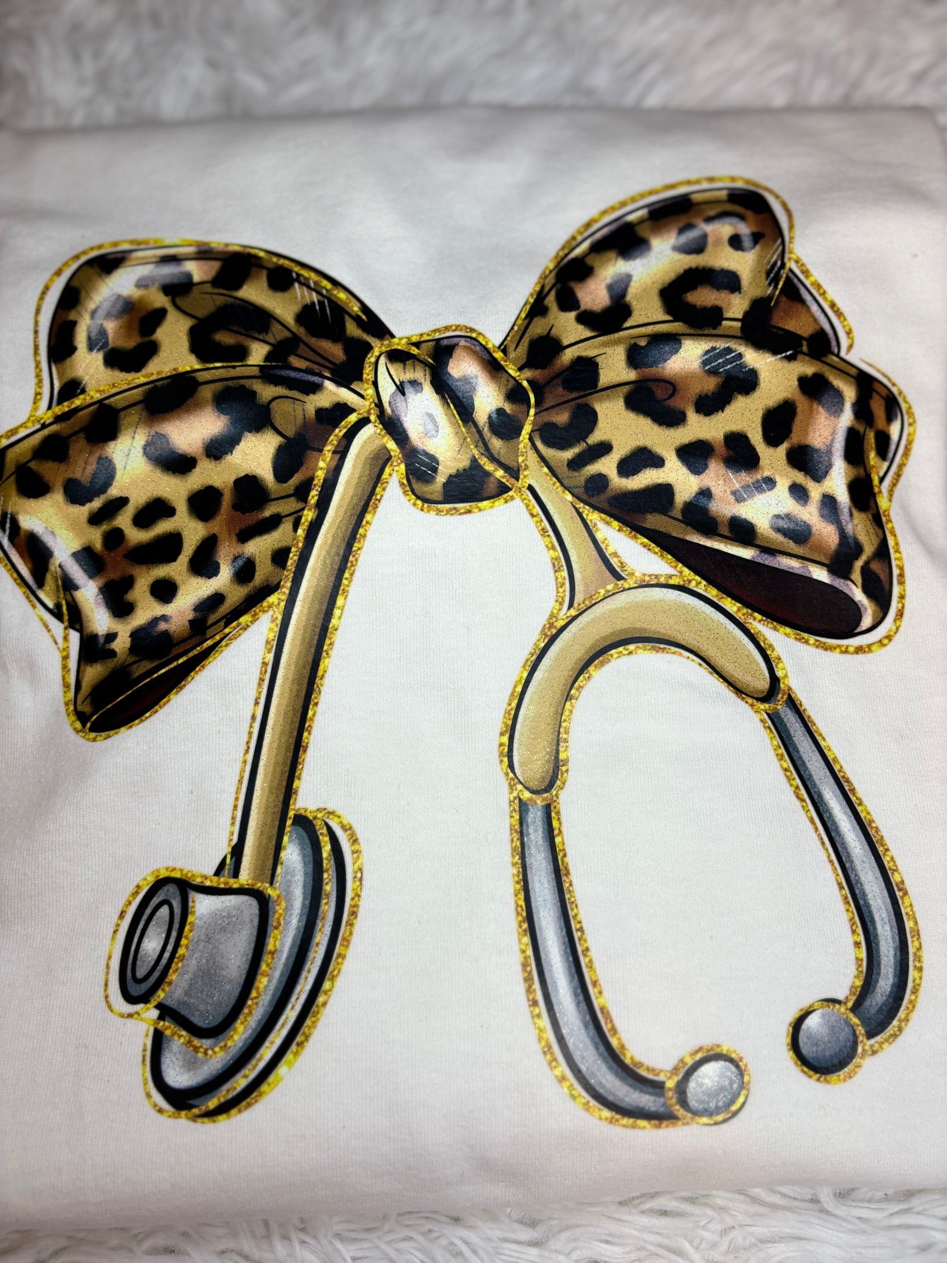 White long sleeve heat pressed t-shirt with a large leopard print bow nurse stethoscope design 